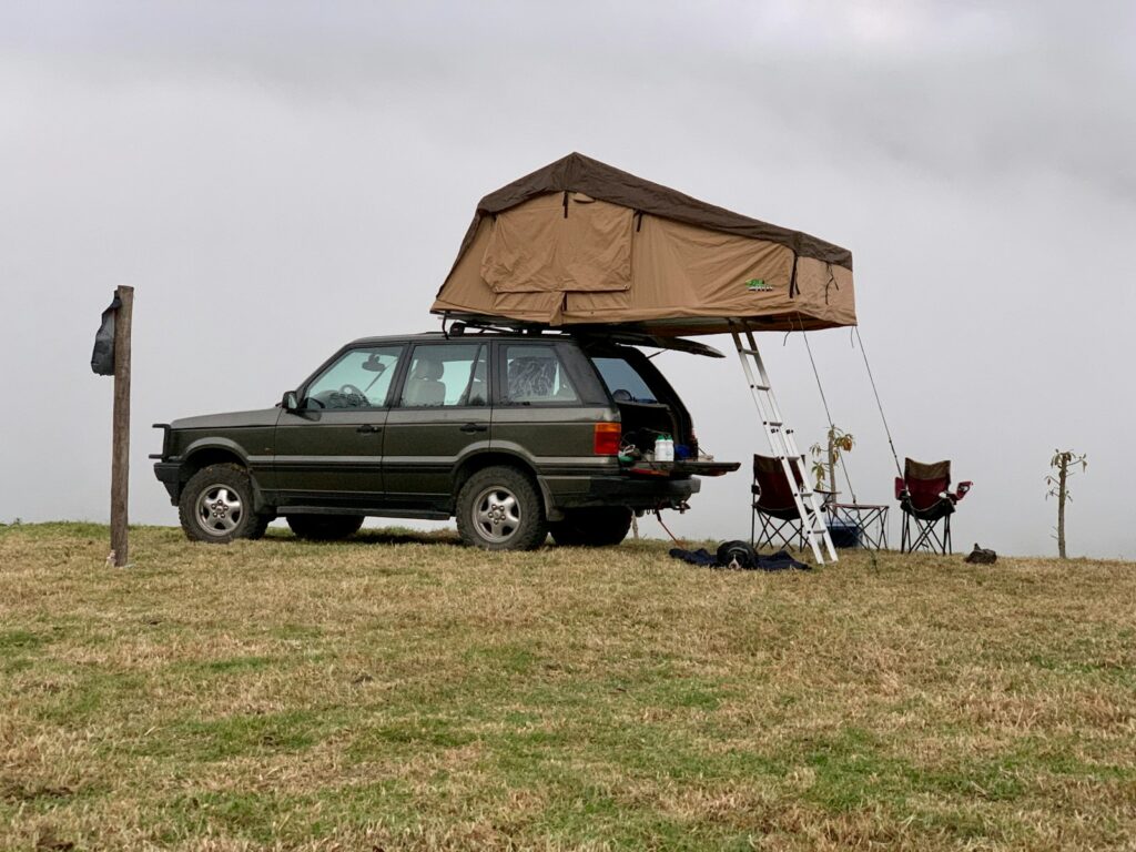 black suv on green grass field during daytime