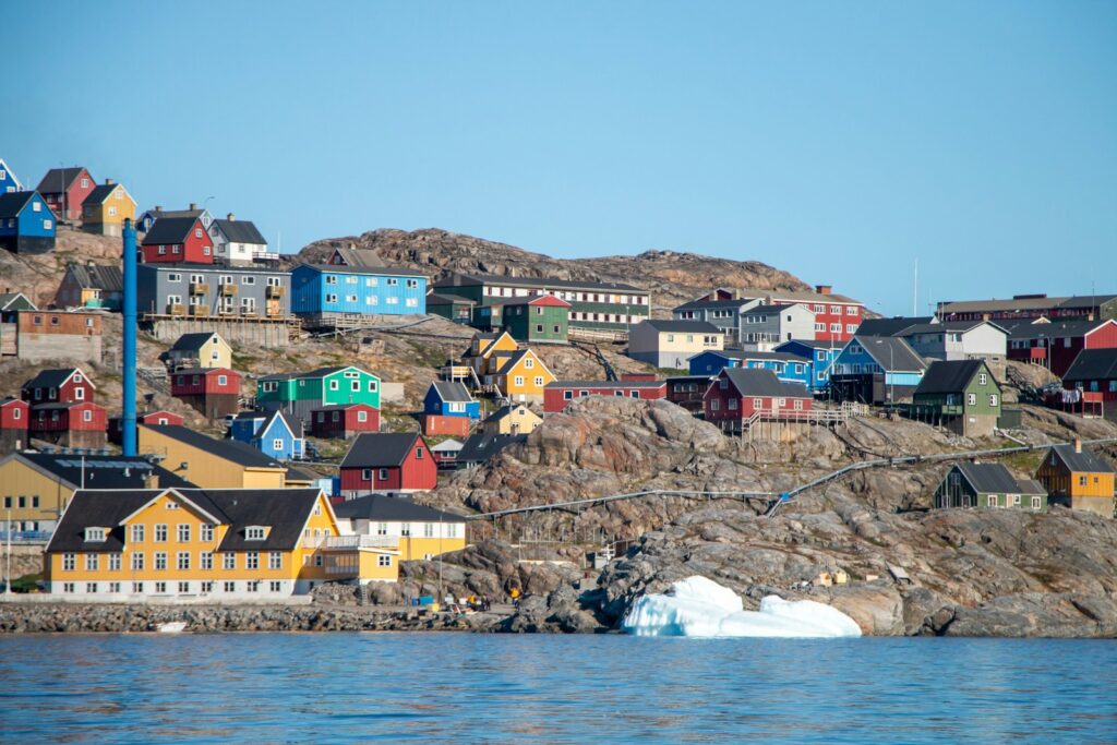 A small town on a hill with a body of water in front of it