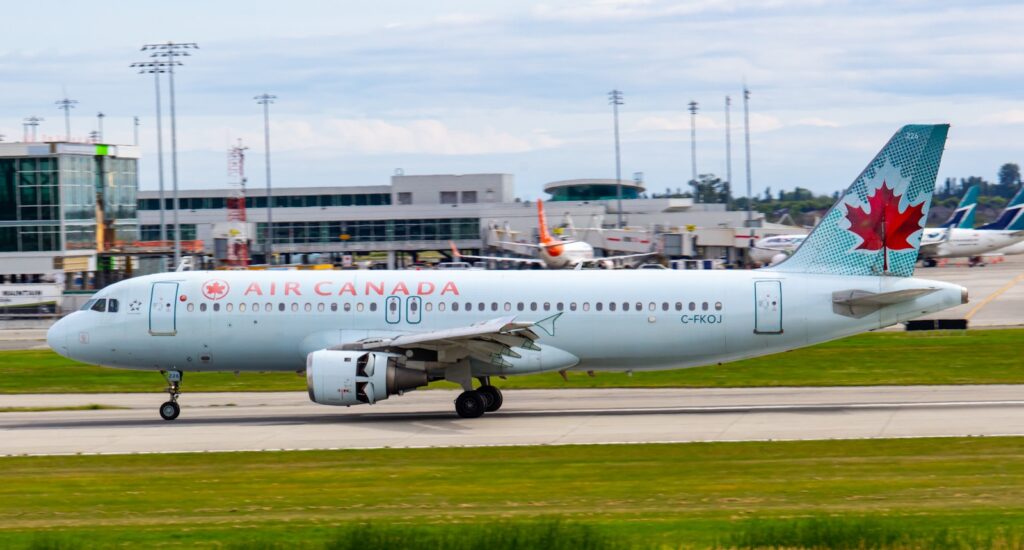 white and red passenger plane on airport during daytime